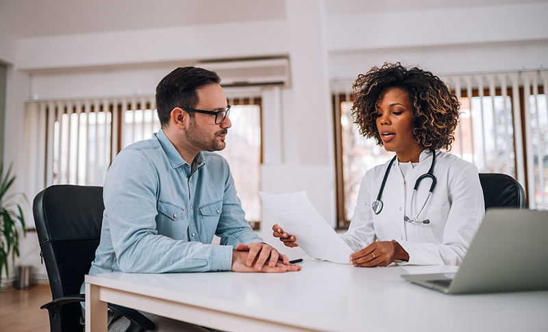 middle age man consulting doctor about colorectal cancer screening